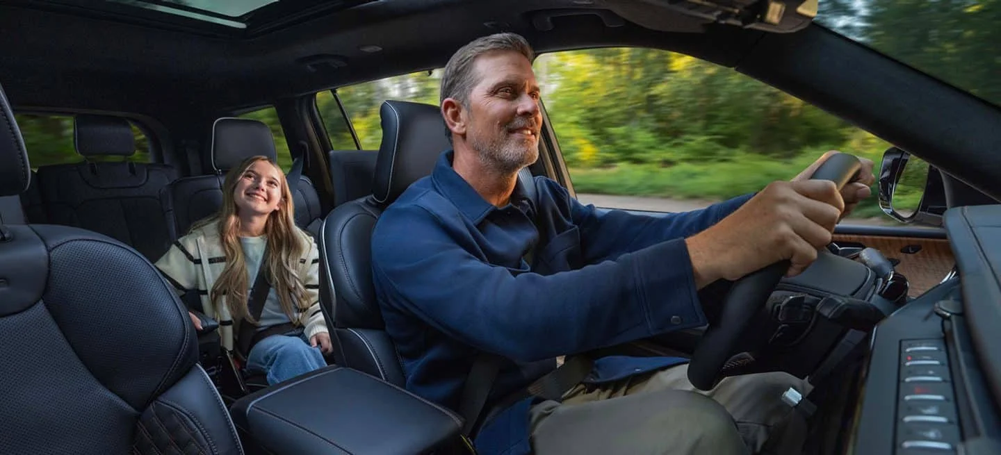 Rear-seat entertainment screens and panoramic roof inside a 2026 Jeep Grand Cherokee