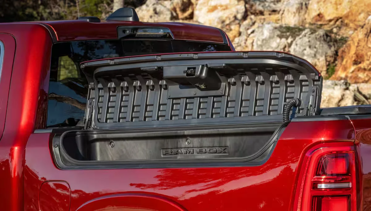 Red 2026 RAM 1500 truck bed storage closeup with the tailgate open